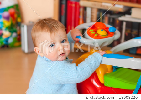 Baby with blue eyes looking at camera, indoors 18908220