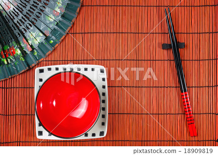 Two chopsticks on sushi mat background Two chopsticks on sushi mat background 18909819