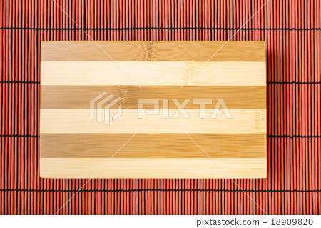 Cutting board on bamboo mat Cutting board on bamboo mat 18909820