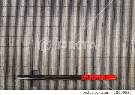 Two chopsticks on sushi mat background Two chopsticks on sushi mat background 18909823