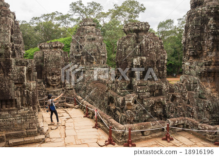 Stone head on towers of Bayon temple Stone head on towers of Bayon temple 18916196