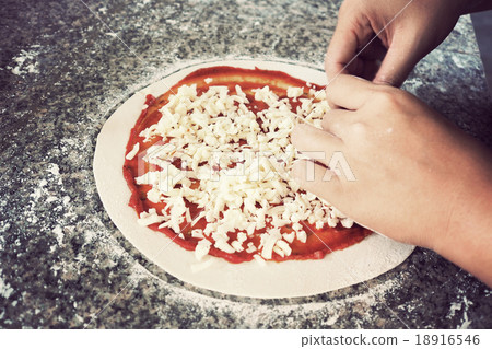 Woman making pizza on table 18916546
