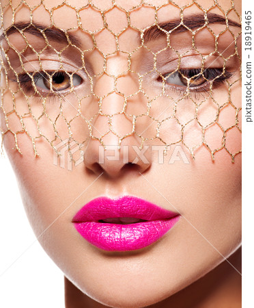 beautiful  woman wears golden veil on face. 18919465
