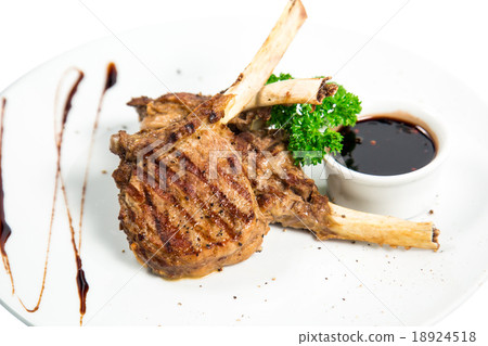 Roasted lamb ribs with spices with the sauce 18924518
