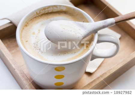 Whipping Cream on a spoon and a cup of coffee  18927982