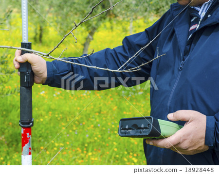 Surveyor with GPS kit at a country roadside 18928448