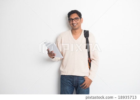 Happy young man using digital tablet Happy young man using digital tablet 18935713