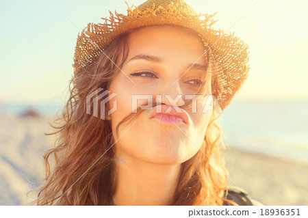Beautiful girl on a beach is kidding Beautiful girl on a beach is kidding 18936351