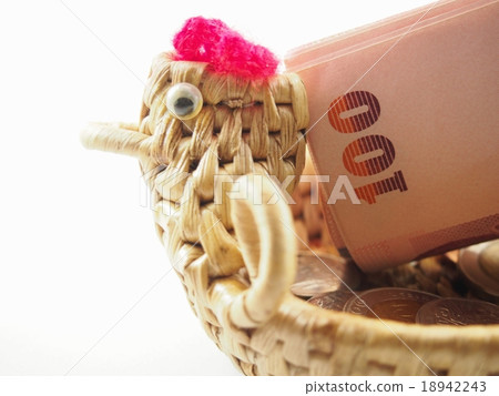 Rolled banknotes on basket with chicken shape 18942243