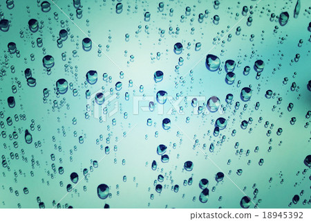 raindrops on glass with reflection of sky. raindrops on glass with reflection of sky. 18945392