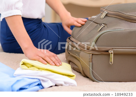 Female tourist unpacking her baggage.  18949233