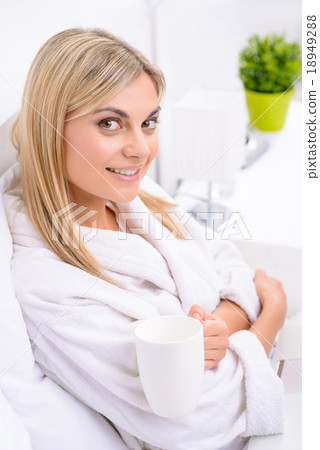 Young woman enjoying her tea.  18949288