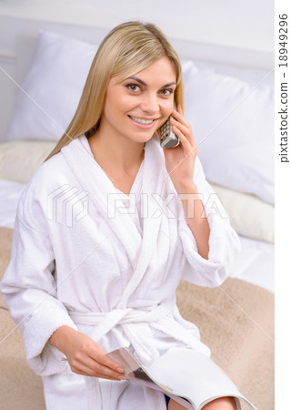 Young woman ordering from catalogue.  18949296