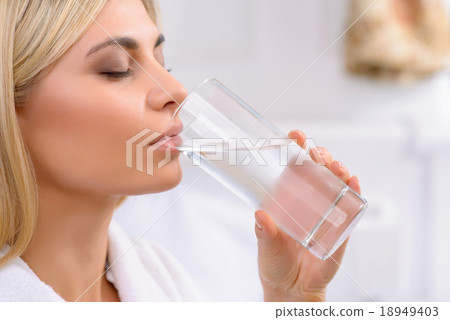 Young lady drinking water. Young lady drinking water. 18949403