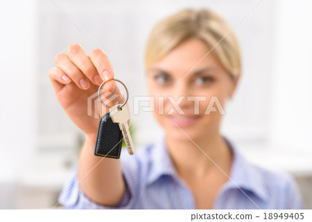 Young woman upholding room key. 18949405
