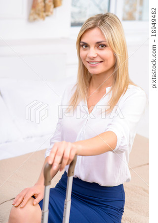 Girl sitting in her hotel suite.  18949482