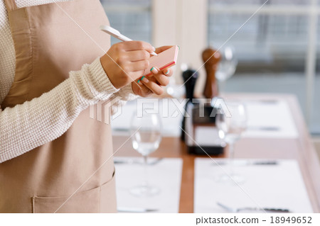 Waitress is writing down an order. Waitress is writing down an order. 18949652