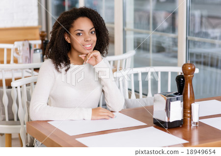 Young lady sitting at the restaurant. Young lady sitting at the restaurant. 18949654
