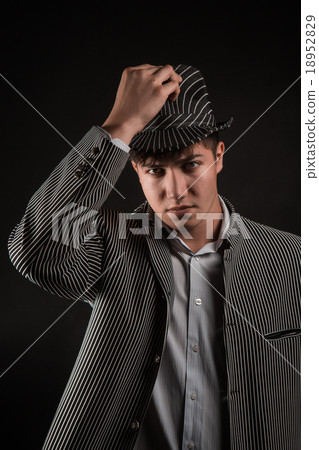 a man in a grey hat on black background a man in a grey hat on black background 18952829