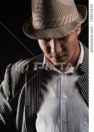 The man in style Chicago gangster dark background The man in style Chicago gangster dark background 18952830