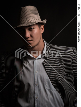 a man in a grey hat on black background a man in a grey hat on black background 18952831