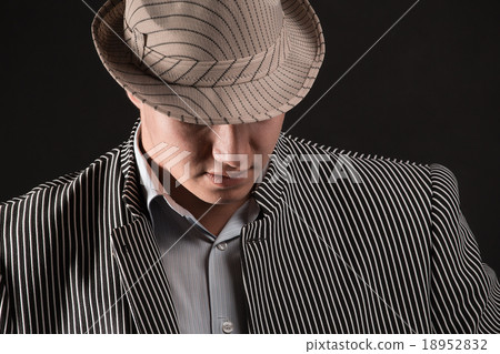 The man in style Chicago gangster dark background 18952832