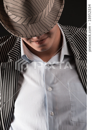 a man in a grey hat on black background a man in a grey hat on black background 18952834