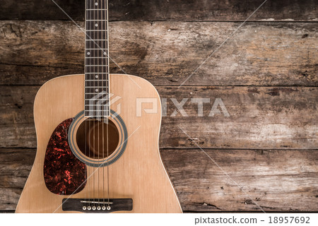 Top view of guitar on dark wood floor texture in d 18957692