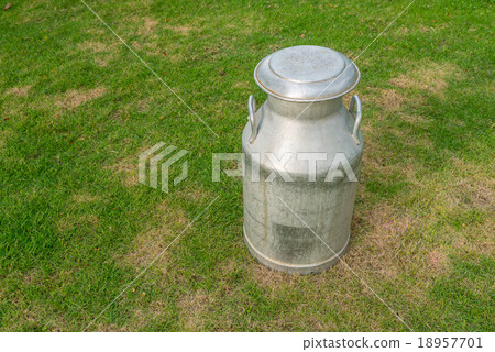 old metal can on milk on green yard 18957701