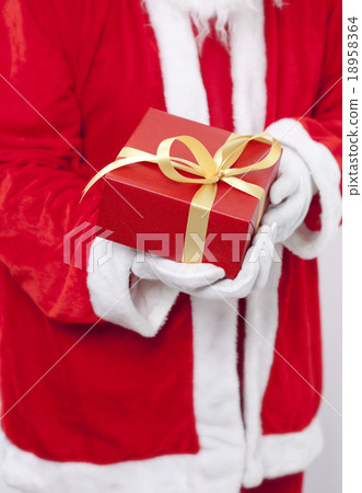 Santa Claus gloved hands holding red giftbox Santa Claus gloved hands holding red giftbox 18958364