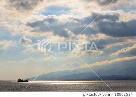 A silhouette of a ship sailing the Messina Strait 18961584