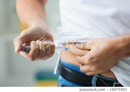 man with syringe making insulin injection man with syringe making insulin injection 18975903