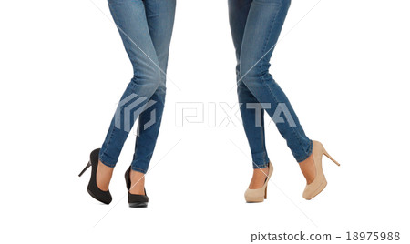 close up of two women legs in jeans 18975988