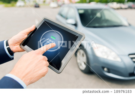 close up of hands with car starter on tablet pc 18976183