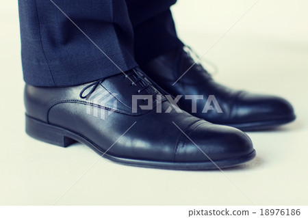 close up of man legs in elegant shoes with laces close up of man legs in elegant shoes with laces 18976186