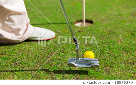close up of man with club and ball playing golf 18976379