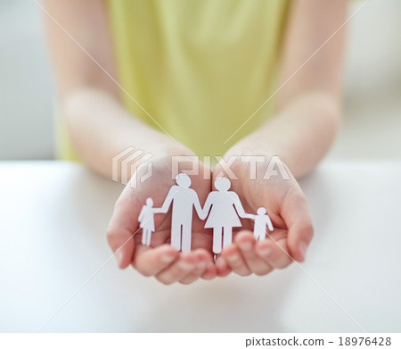 close up of child hands with paper family cutout close up of child hands with paper family cutout 18976428