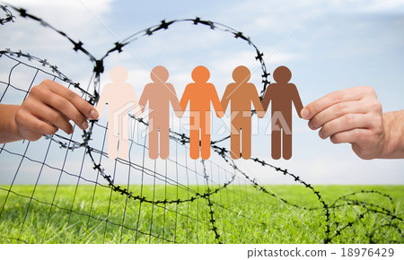 hands holding people pictogram over barb wire hands holding people pictogram over barb wire 18976429