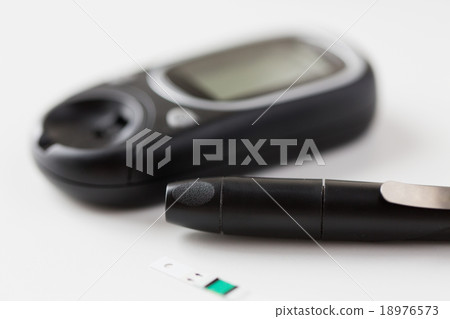close up of glucometer and blood sugar test stick 18976573