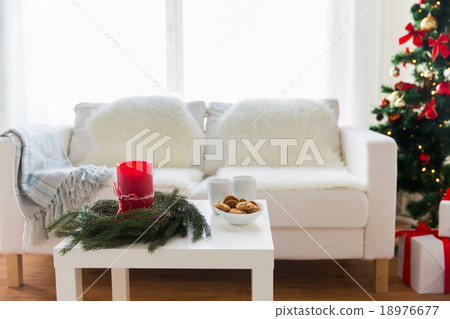 sofa, table and christmas tree with gifts at home 18976677