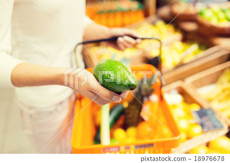 close up of woman with food basket in market 18976678
