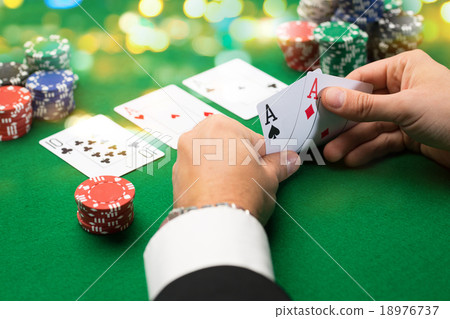 Stock Photo: poker player with cards and chips at casino