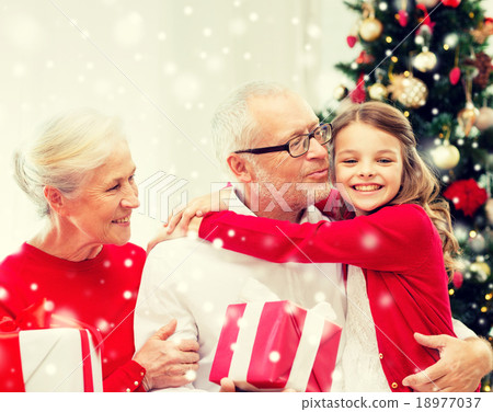smiling family with gifts at home smiling family with gifts at home 18977037