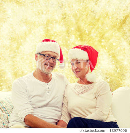 happy senior couple in santa helper hats happy senior couple in santa helper hats 18977096