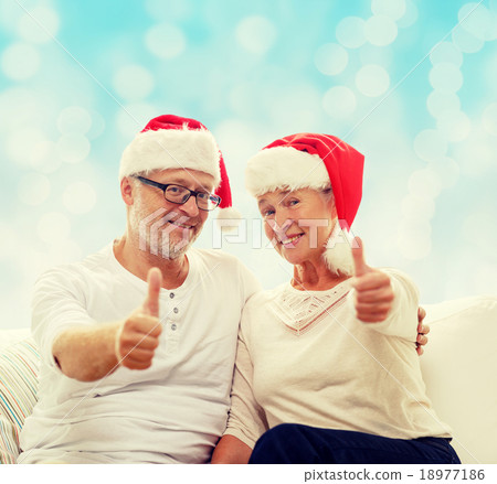 happy senior couple in santa helper hats 18977186