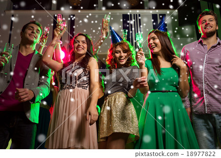 smiling friends with glasses of champagne in club 18977822