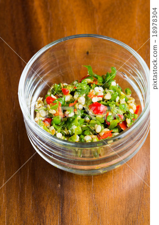 Sliced chilli in a small bowl on wooden table Sliced chilli in a small bowl on wooden table 18978304