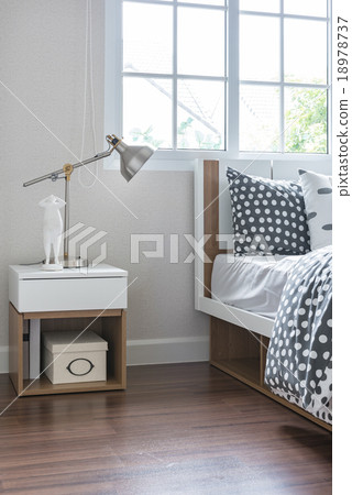 Stock Photo: modern lamp on bedside table with wooden bed