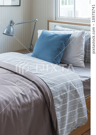 Stock Photo: modern lamp on bedside table with wooden bed