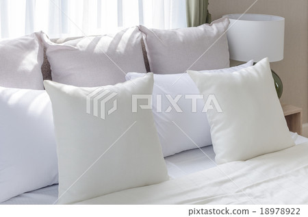 Stock Photo: white pillows on modern white bed with lamp